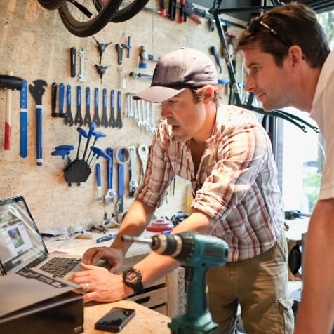 bike-shop-owner-discussing-products-with-client